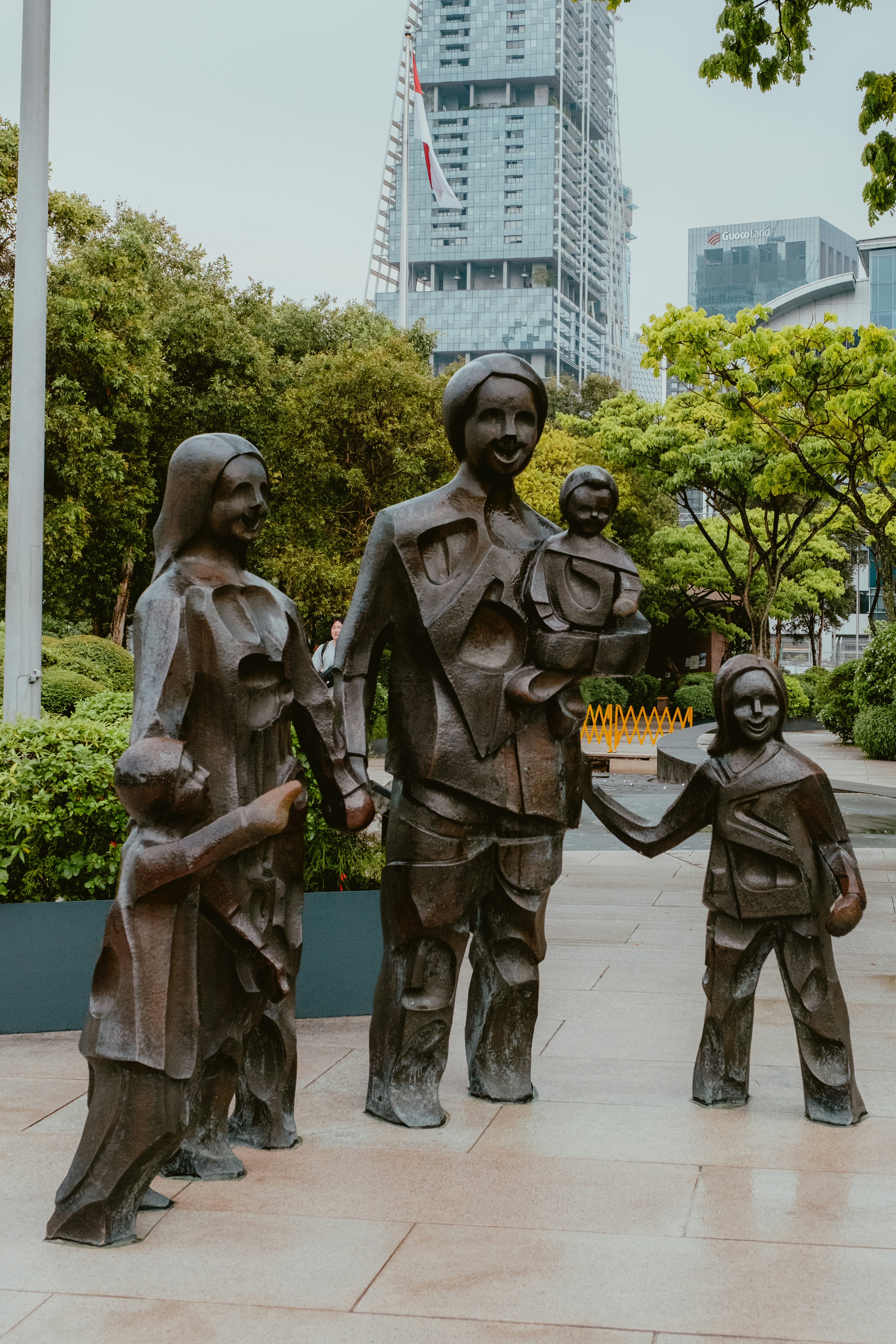 Bronze sculpture of a family in a park